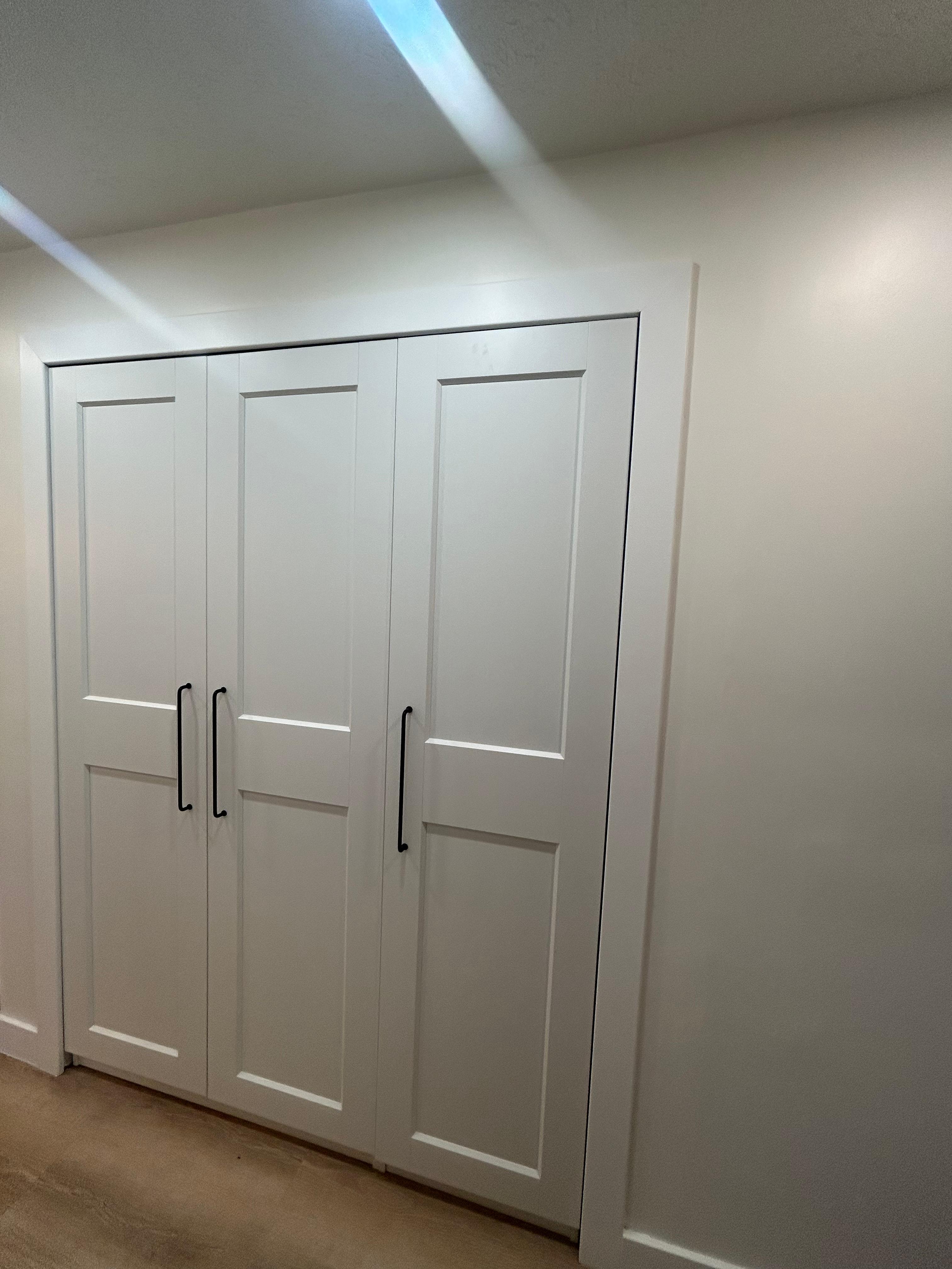 Custom-framed IKEA closet system designed for a seamless built-in look.